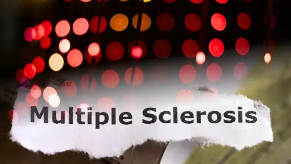 An image of Multiple Sclerosis word with red light background